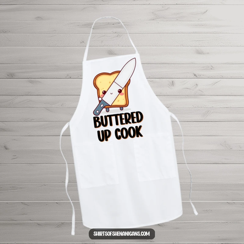 Funny shy toast apron, peeking from behind a giant butter knife, for humorous and cute kitchen protection.