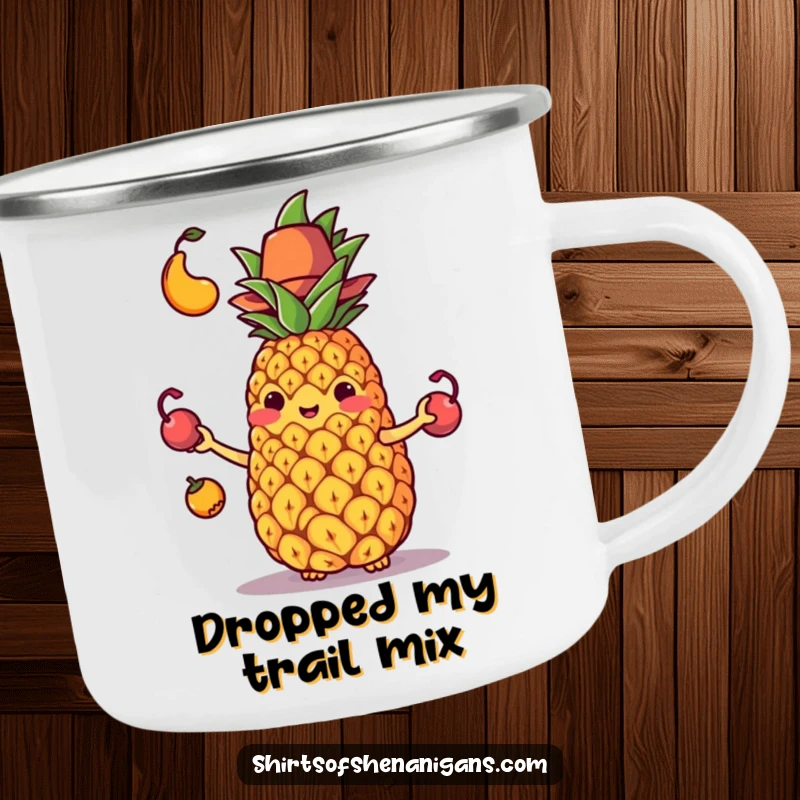 Funny, durable camping mug with a juggling pineapple in a small hat comically dropping its fruit, ready for adventure.