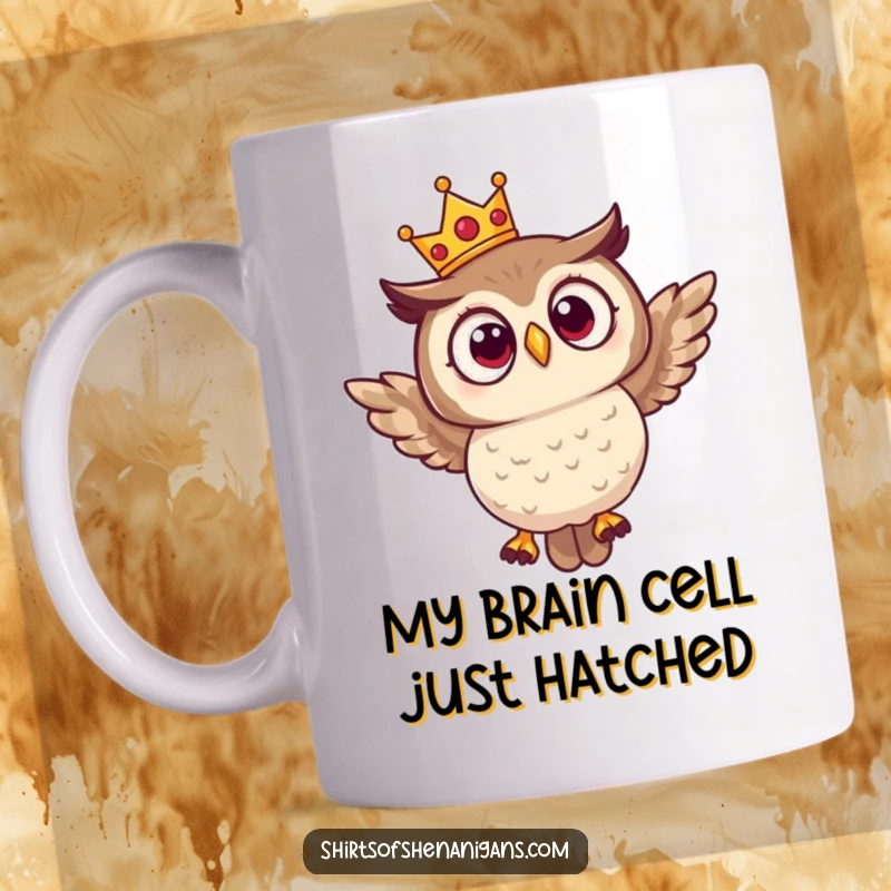 Funny mug featuring a surprised owl in a tiny crown, comically attempting to fly with a determined yet clueless expression.