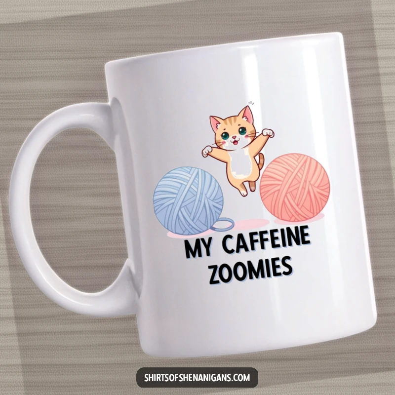 Funny cat mug showing a sleek feline mid-leap between two huge balls of yarn, full of playful energy. A great funny gift.