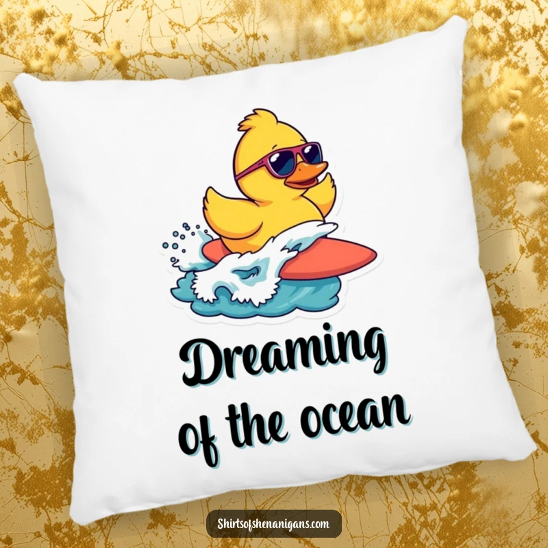 Funny pillow with a rubber duck wearing sunglasses, surfing a wave, adding a touch of beachy fun.