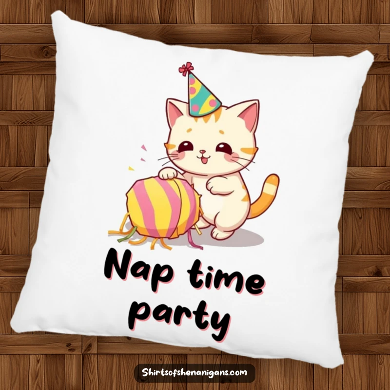 Funny throw pillow with a cat wearing a party hat accidentally knocking over a piñata, festive comfort.