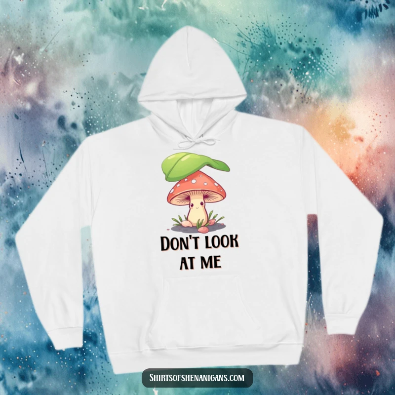 Funny shy mushroom hiding under a leaf, printed on a warm and cozy hoodie, perfect for introverts and fungi fans.