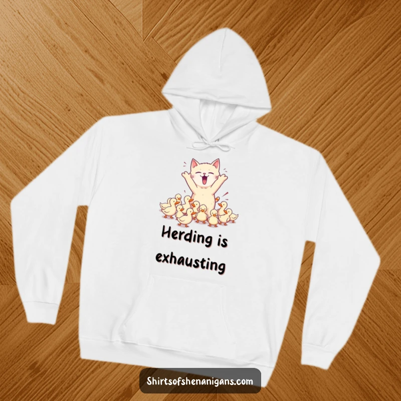Funny hoodie showing a chaotic cat herding ducks, embodying pet owner humor and providing cozy, funny gift.