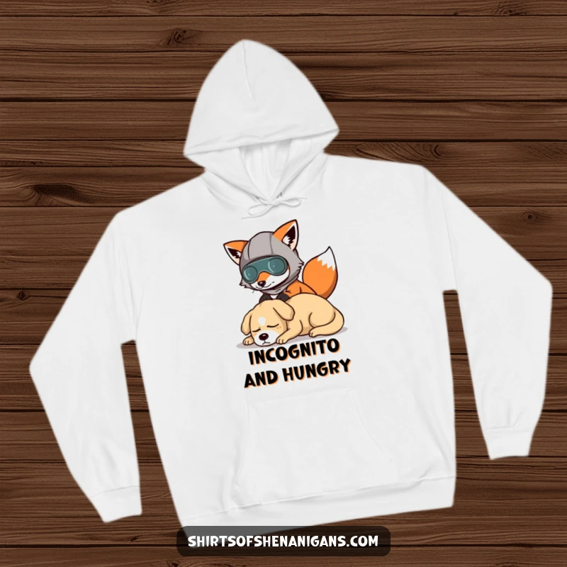 Funny hoodie depicting a fox in a comical disguise, attempting a silent, humorous escape past a slumbering canine.