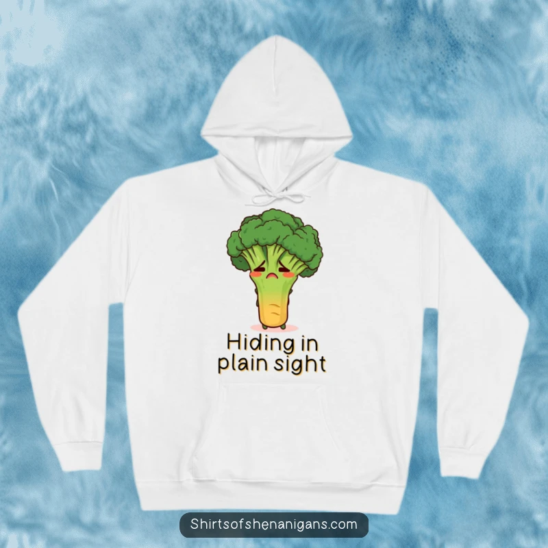 Funny embarrassed broccoli stalk hiding behind a carrot on a soft hoodie, perfect for cozy and humorous wear.