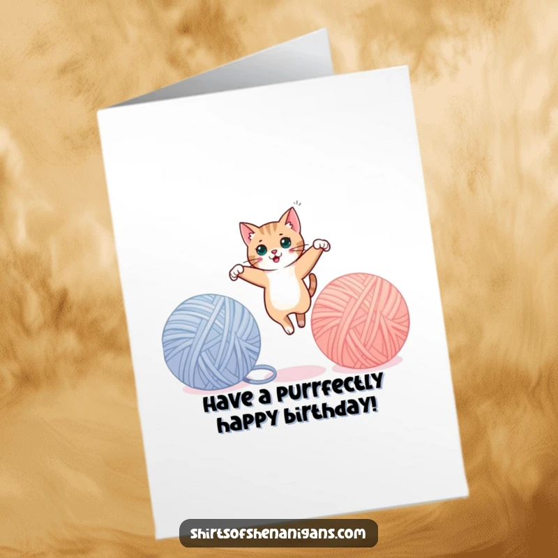 Funny Free Printable Birthday Card: A sleek cat leaps gracefully between two giant yarn balls, celebrating the day.