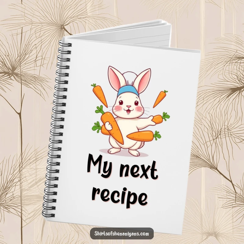 Funny notebook with a rabbit in a chef hat hilariously juggling oversized carrots, perfect for recipe notes and kitchen inspiration.