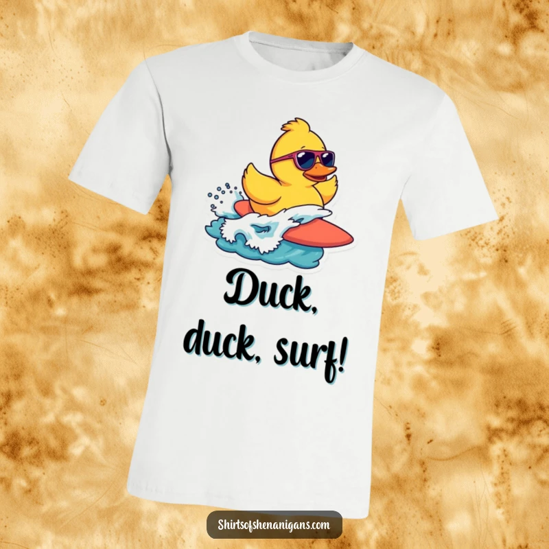 Funny t-shirt with a cool rubber duck wearing sunglasses, confidently surfing a wave with a relaxed attitude.