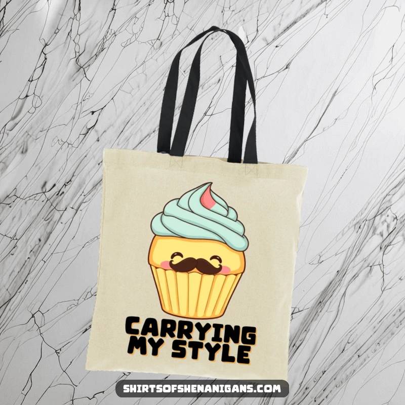 Funny tote bag featuring a giggling cupcake frosting its own mustache, perfect for carrying groceries or baked goods.