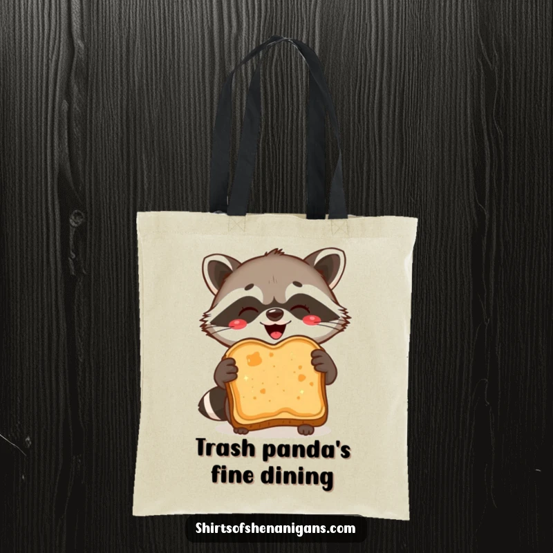 Funny Tote Bag: Delighted raccoon proudly holds burnt toast, perfect for humorous grocery runs.
